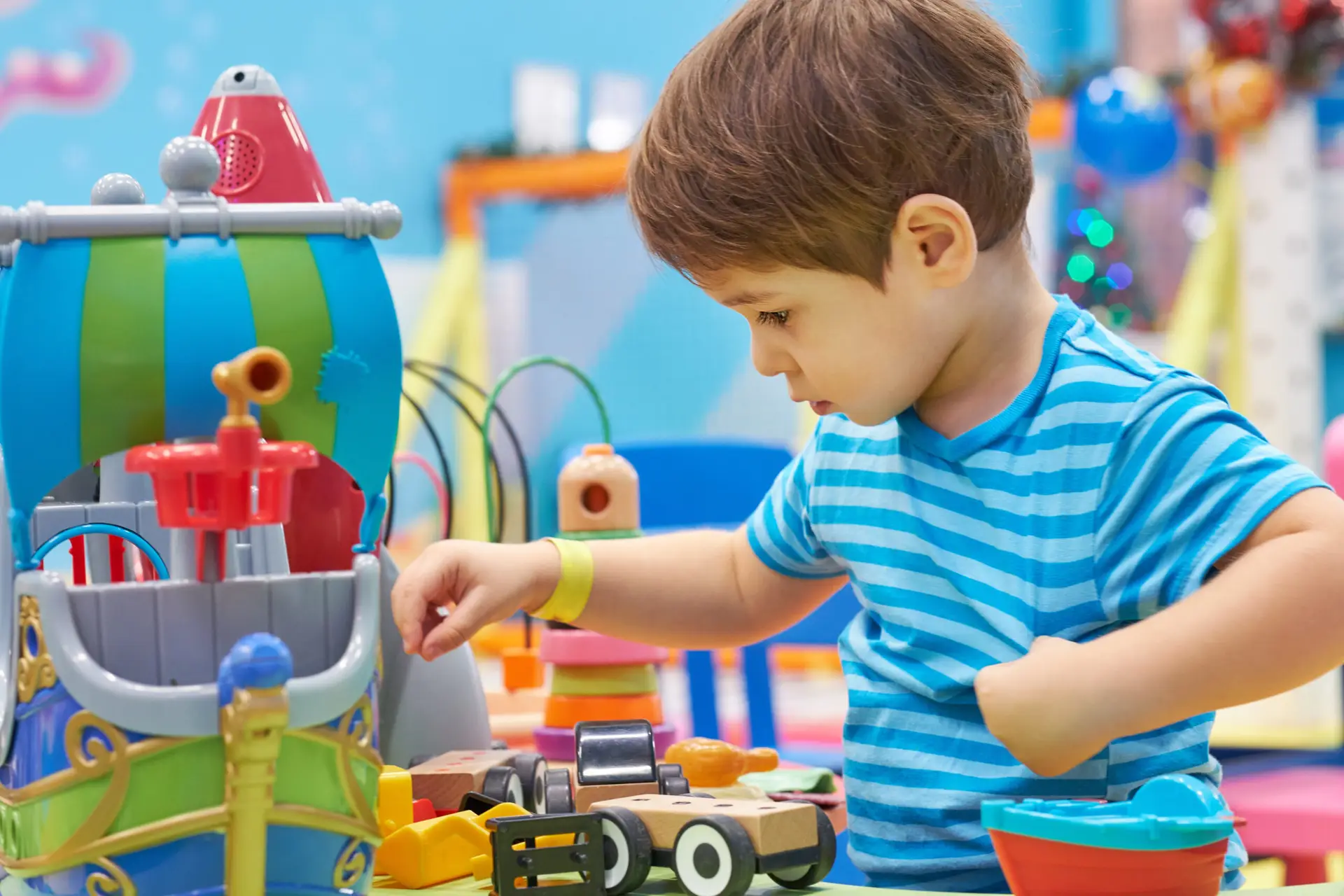 Toddler playing with brightly colored toys