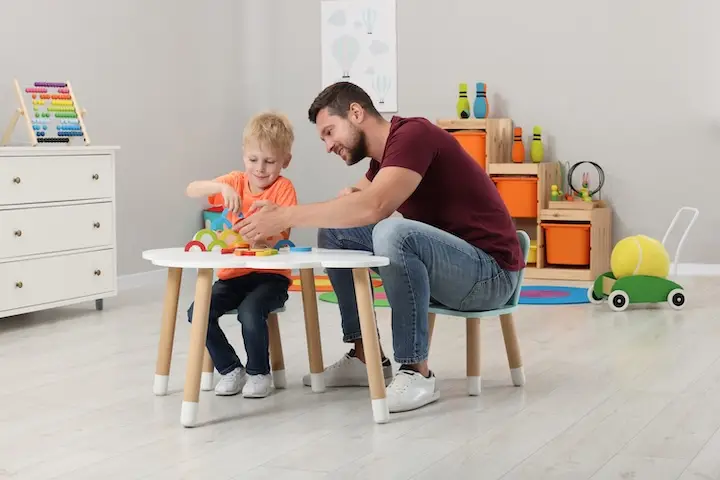 Therapist helping child with toys at table