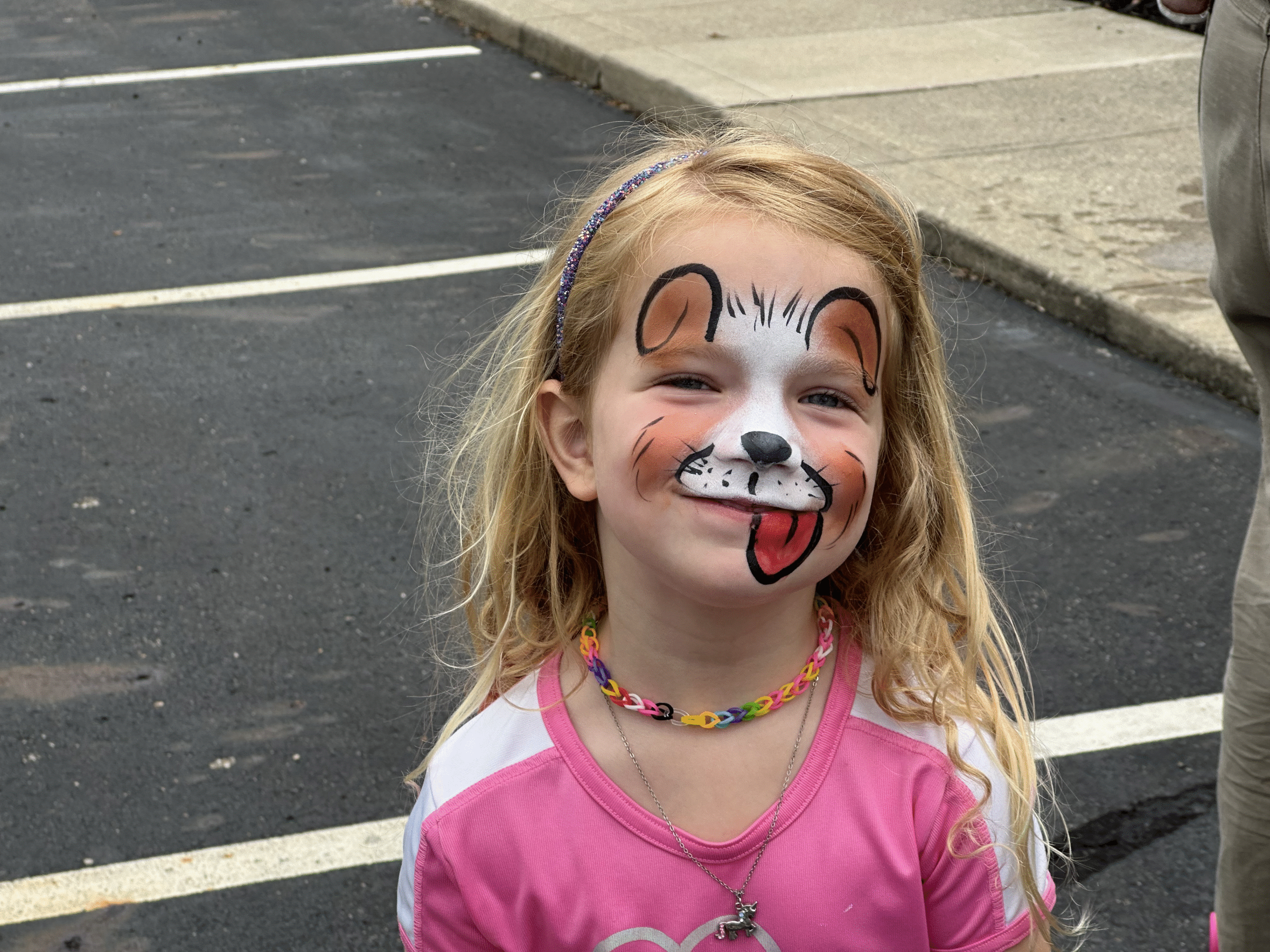 young girl with facepainting having fun