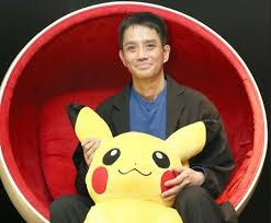 Satoshi Tajiri holding a Pikachu plush, the creator of Pokémon and an individual with Autism Spectrum Disorder.